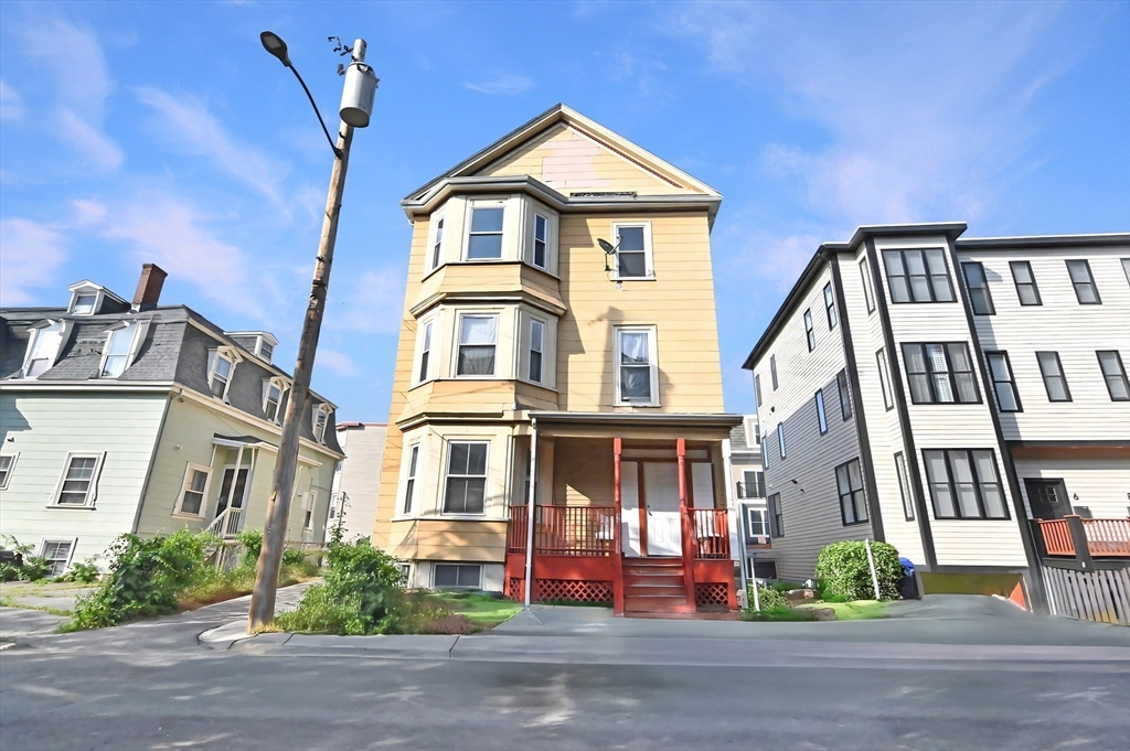 a front view of a house with a street