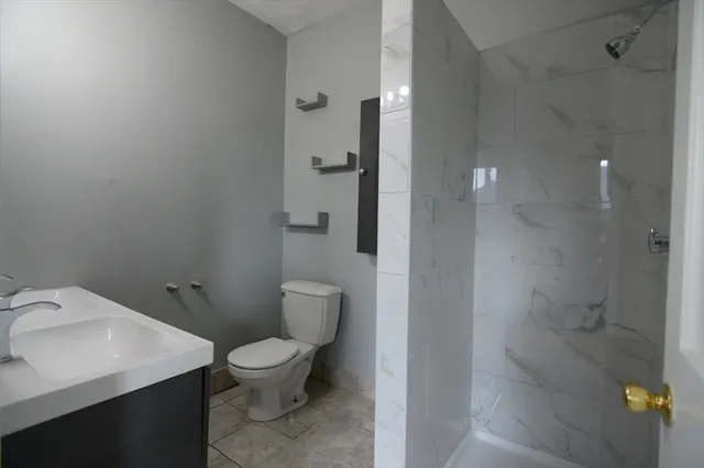 a bathroom with a toilet a sink and shower