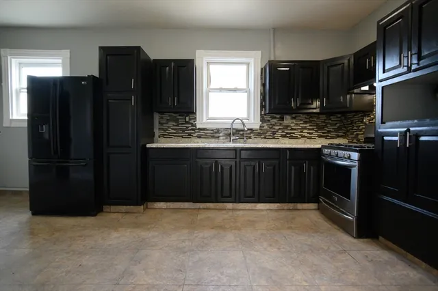 a kitchen with a refrigerator and a sink