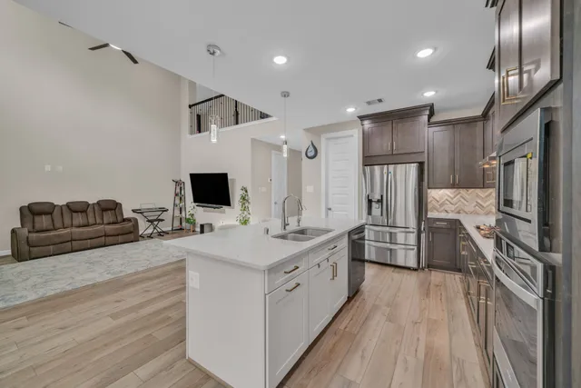 a large white kitchen with a large window