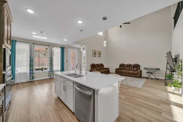 a open kitchen with stainless steel appliances granite countertop a lot of counter space and wooden floor