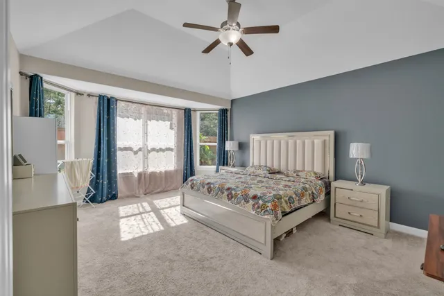 a spacious bedroom with a bed and a large window