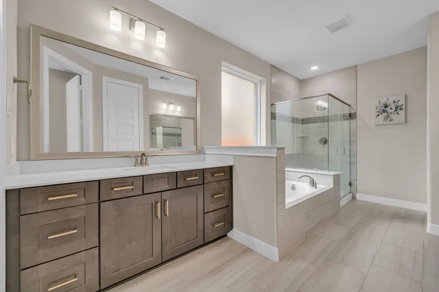 a spacious bathroom with a granite countertop sink mirror and double