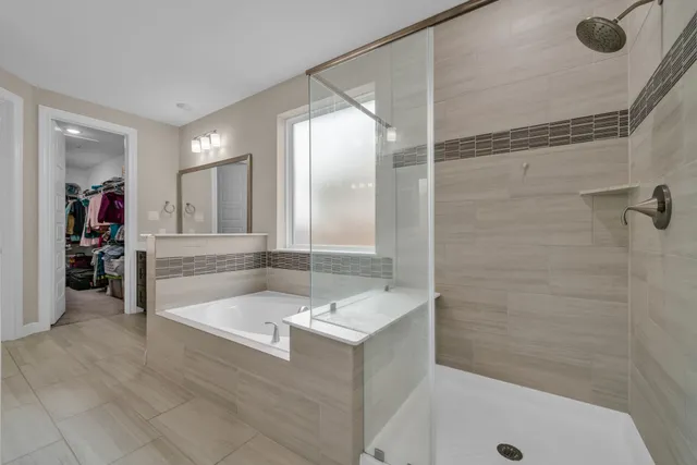 a bathroom with a tub a sink and mirror