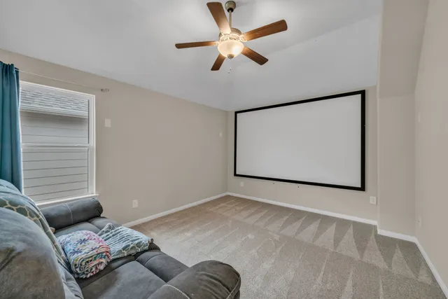 a bedroom with a bed and a ceiling fan