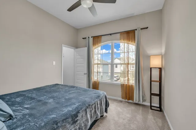 a bedroom with a large bed and a window