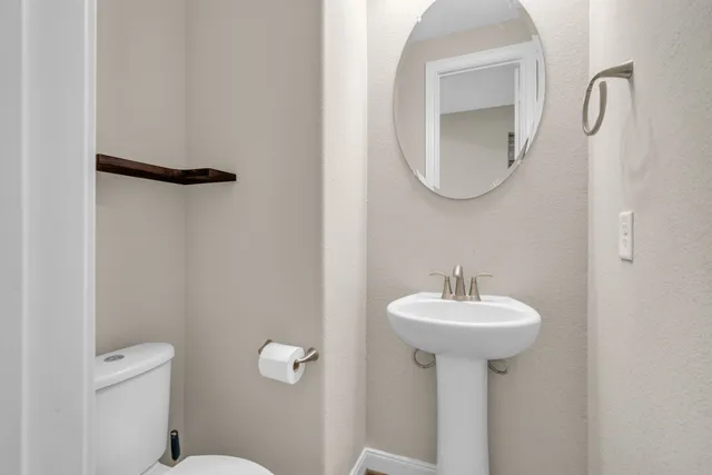 a bathroom with a sink a mirror and a toilet