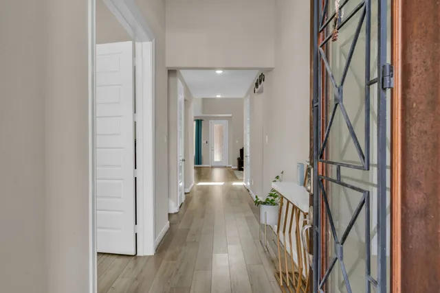 a view of hallway with wooden floor and stairs