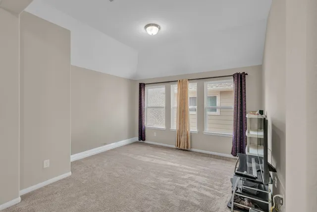 an empty room with windows and closet