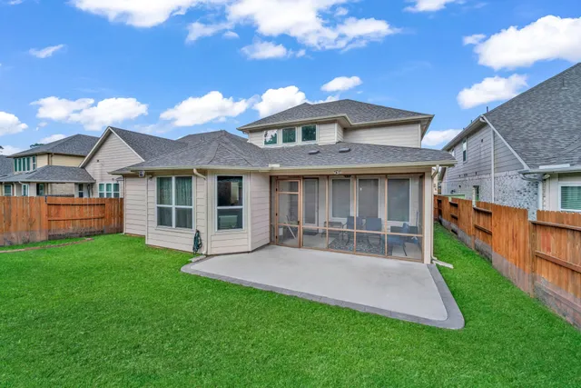a view of a house with a yard and sitting area