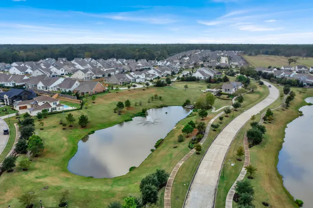 an aerial view of a house with a yard and lake view