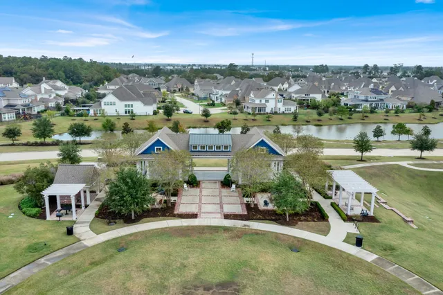 an aerial view of residential houses with outdoor space and river