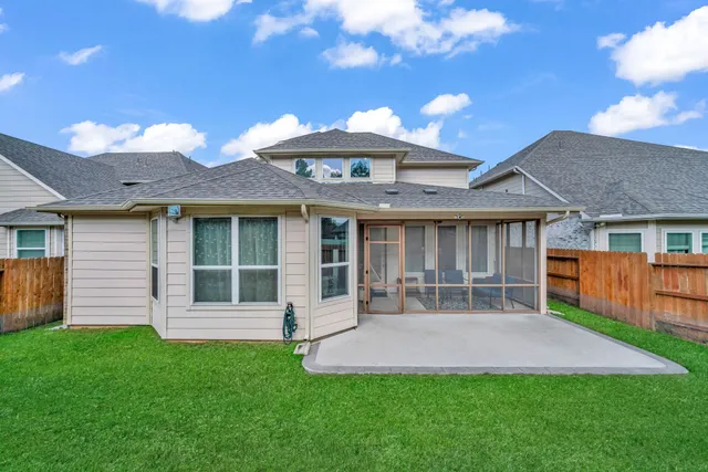 a front view of a house with a garden and yard