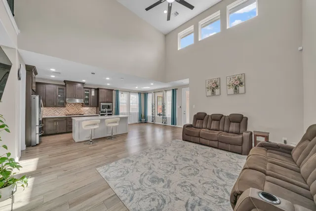 a living room with furniture and kitchen view