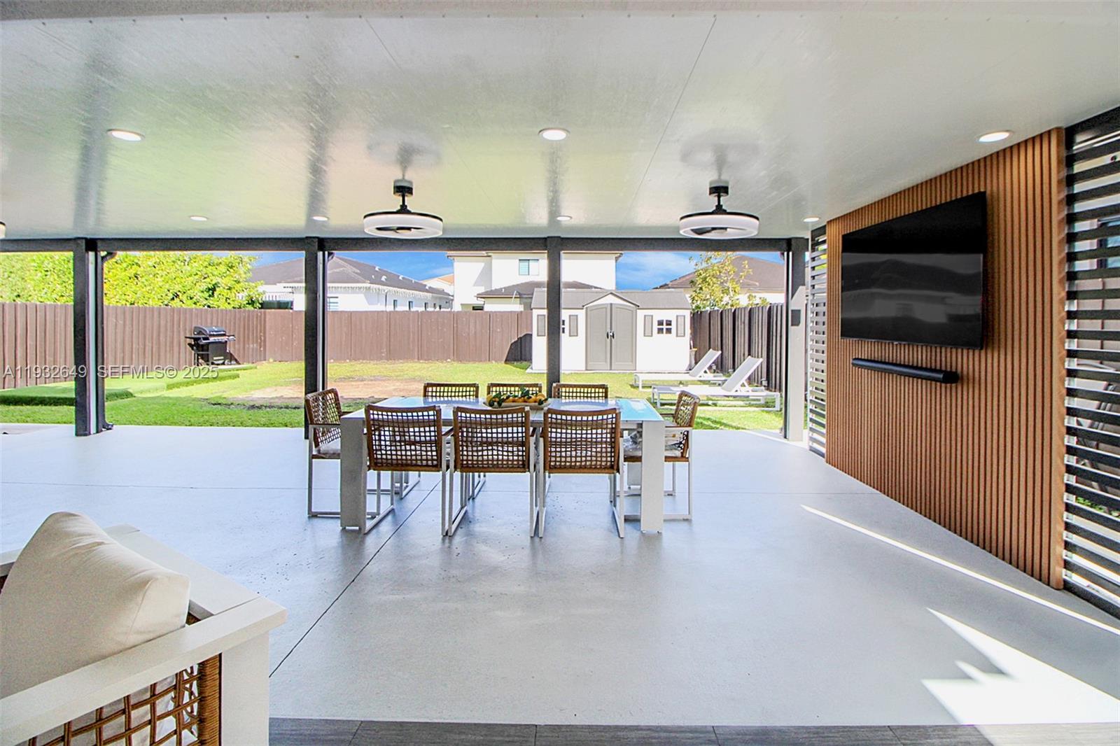 14671 Southwest 20th Street Miami, FL 33175 - Photo 11 of 53 a living room with furniture a flat screen tv and floor to ceiling window