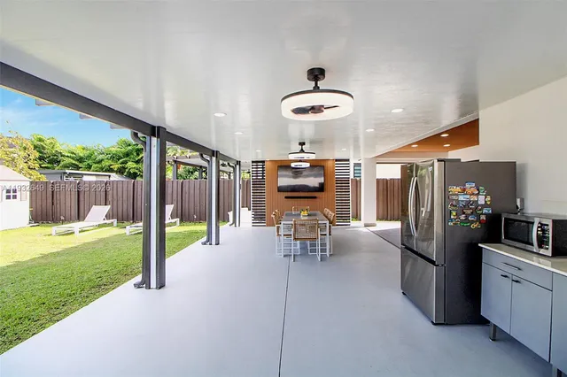 a view of a chairs and table in patio with a yard
