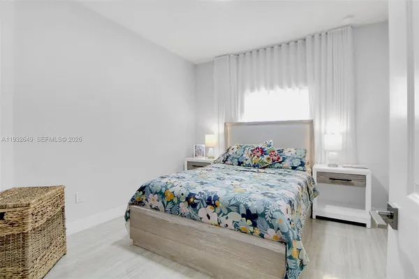 a bedroom with a bed and a television