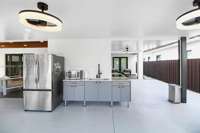 a kitchen with stainless steel appliances granite countertop a refrigerator and a stove top oven