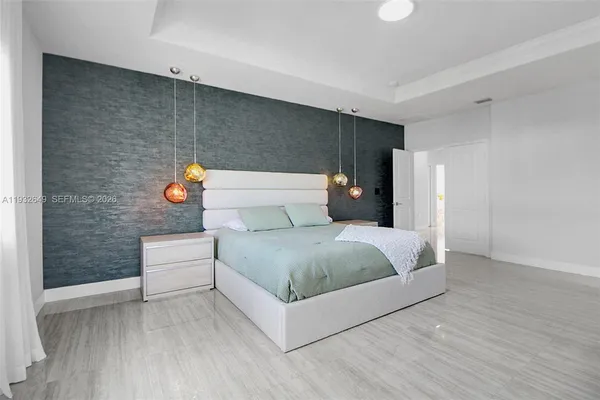 a bedroom with a bed and flat screen tv