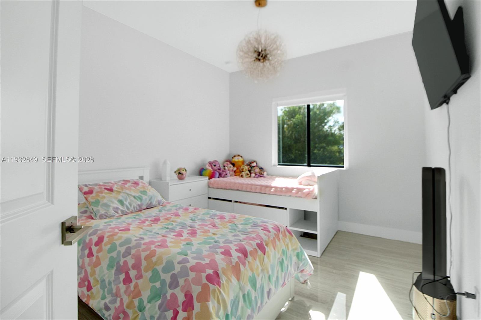 14671 Southwest 20th Street Miami, FL 33175 - Photo 26 of 50 a bedroom with a bed and flat screen tv