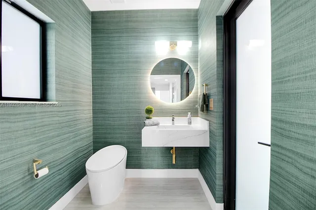 a bathroom with a toilet a sink and mirror