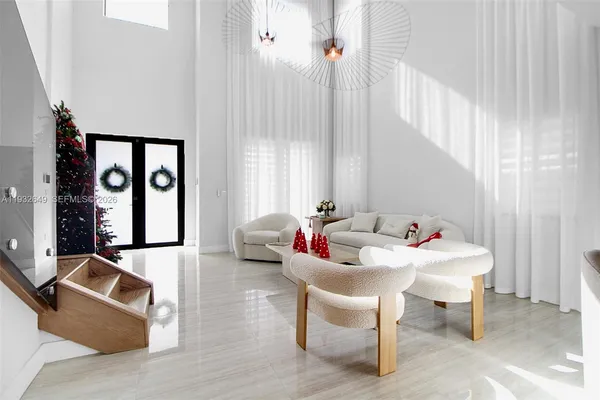 a living room with furniture and a large window