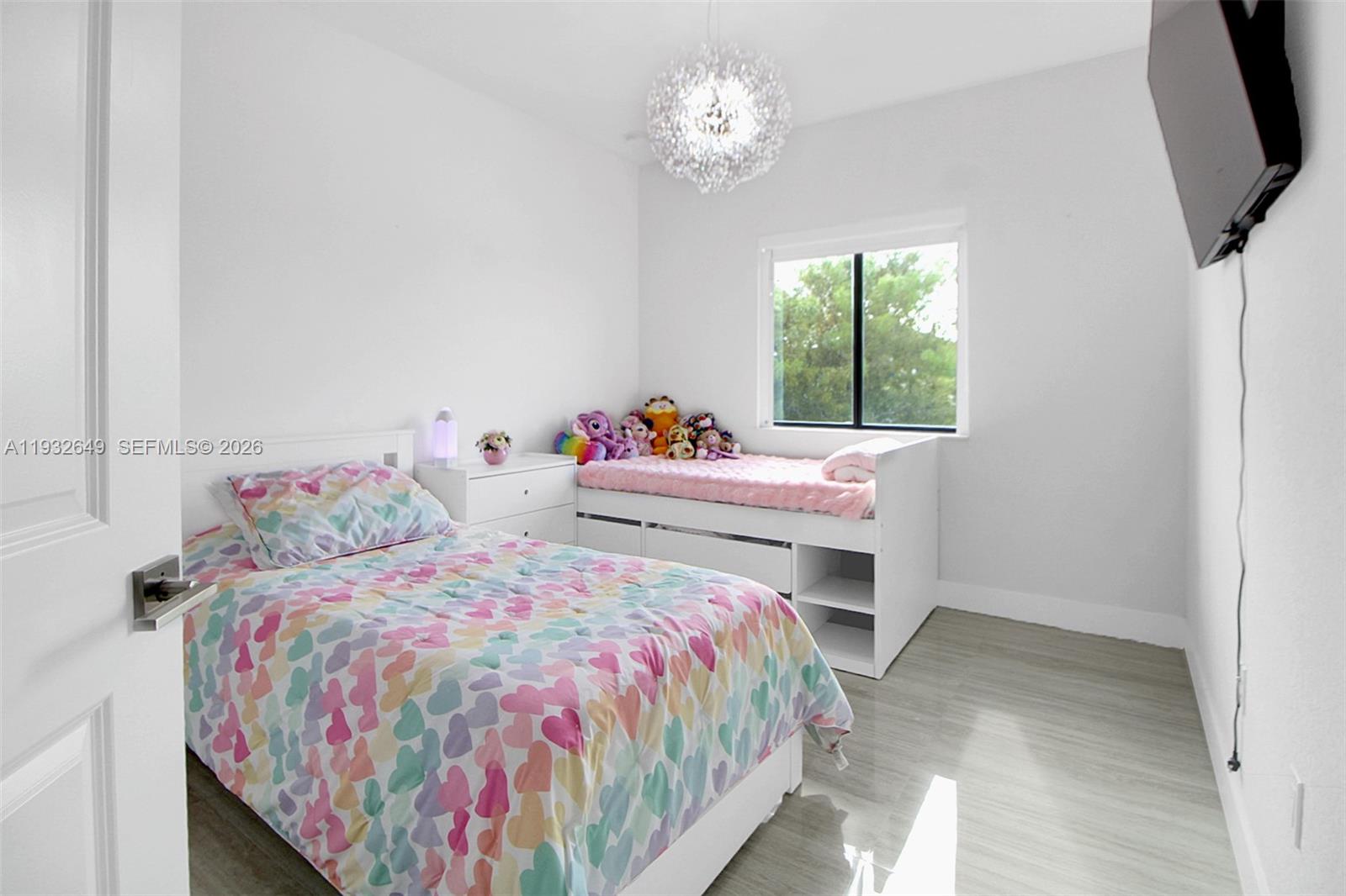 14671 Southwest 20th Street Miami, FL 33175 - Photo 33 of 50 a bedroom with a bed and a chandelier