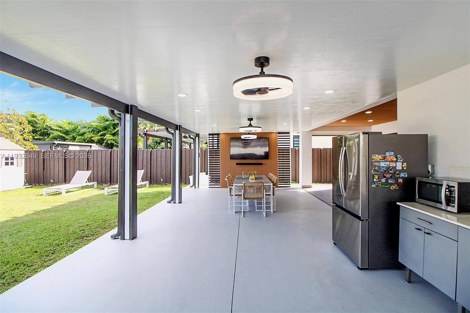 14671 Southwest 20th Street Miami, FL 33175 - Photo 39 of 50 a view of a chairs and table in patio with a yard