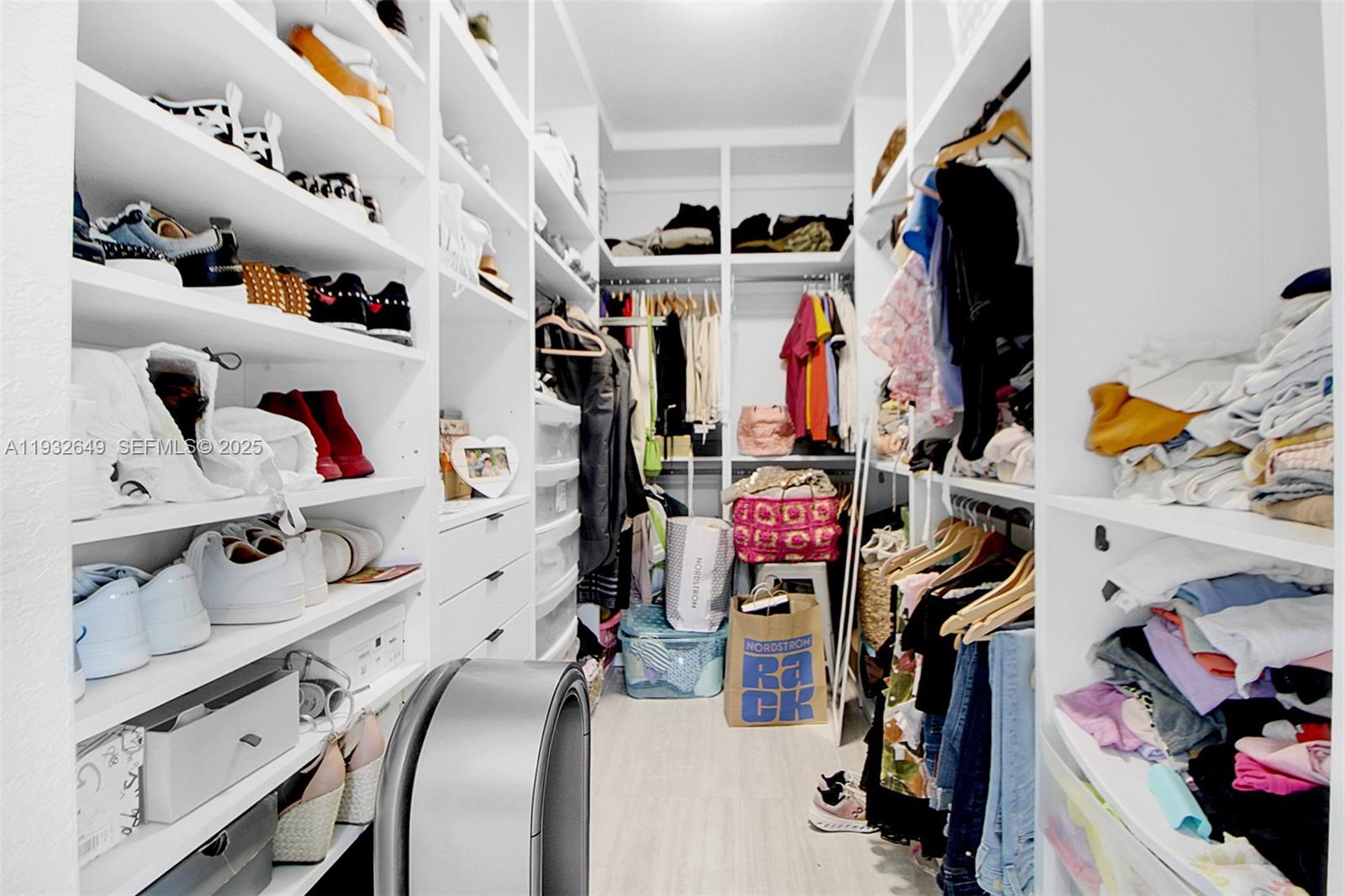 14671 Southwest 20th Street Miami, FL 33175 - Photo 39 of 53 a view of walk in closet with clothes and shoes
