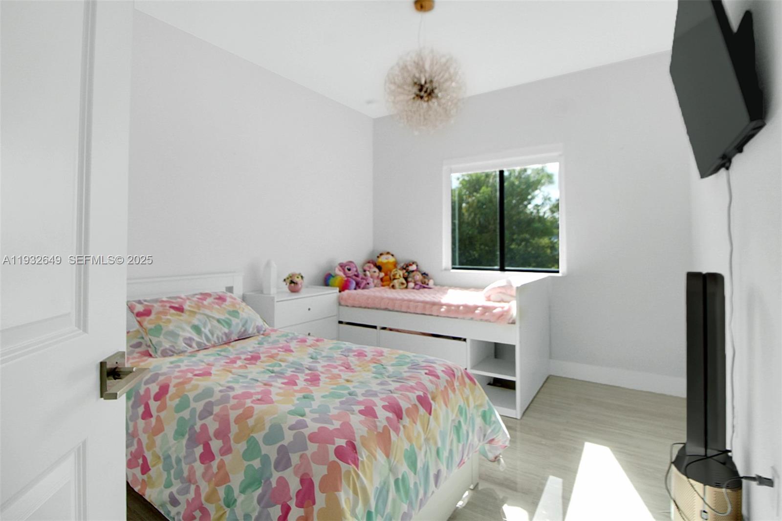 14671 Southwest 20th Street Miami, FL 33175 - Photo 45 of 53 a bedroom with a bed and flat screen tv