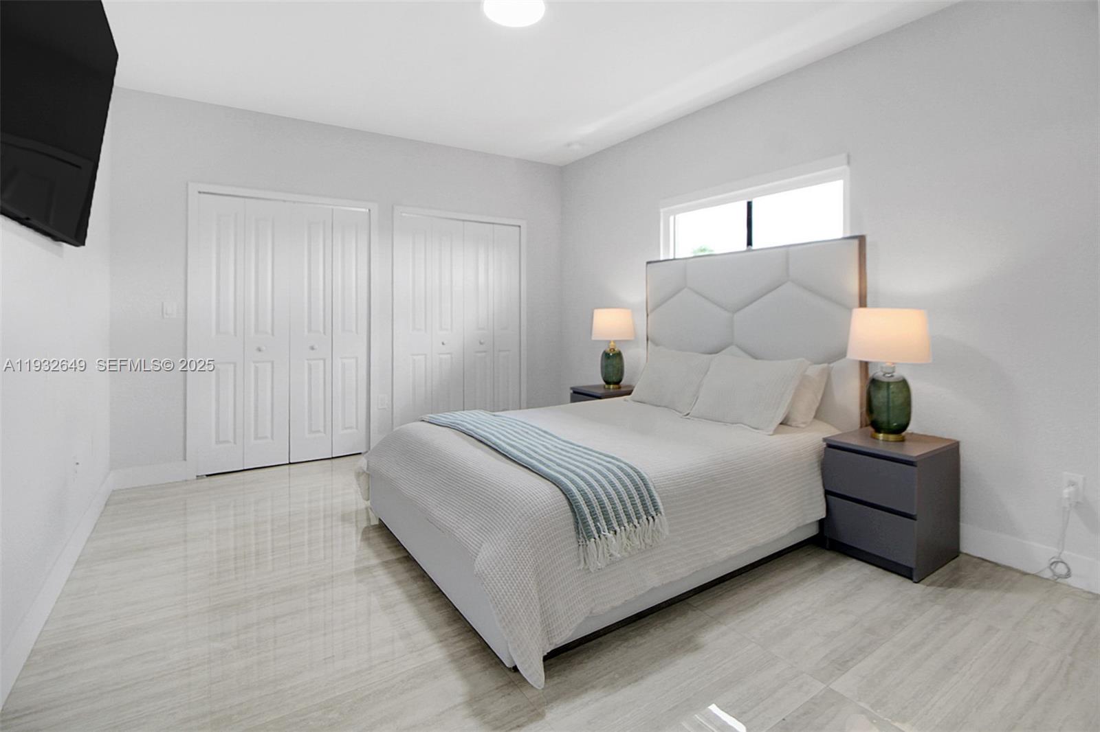 14671 Southwest 20th Street Miami, FL 33175 - Photo 46 of 53 a bedroom with a bed and a flat tv screen on dresser