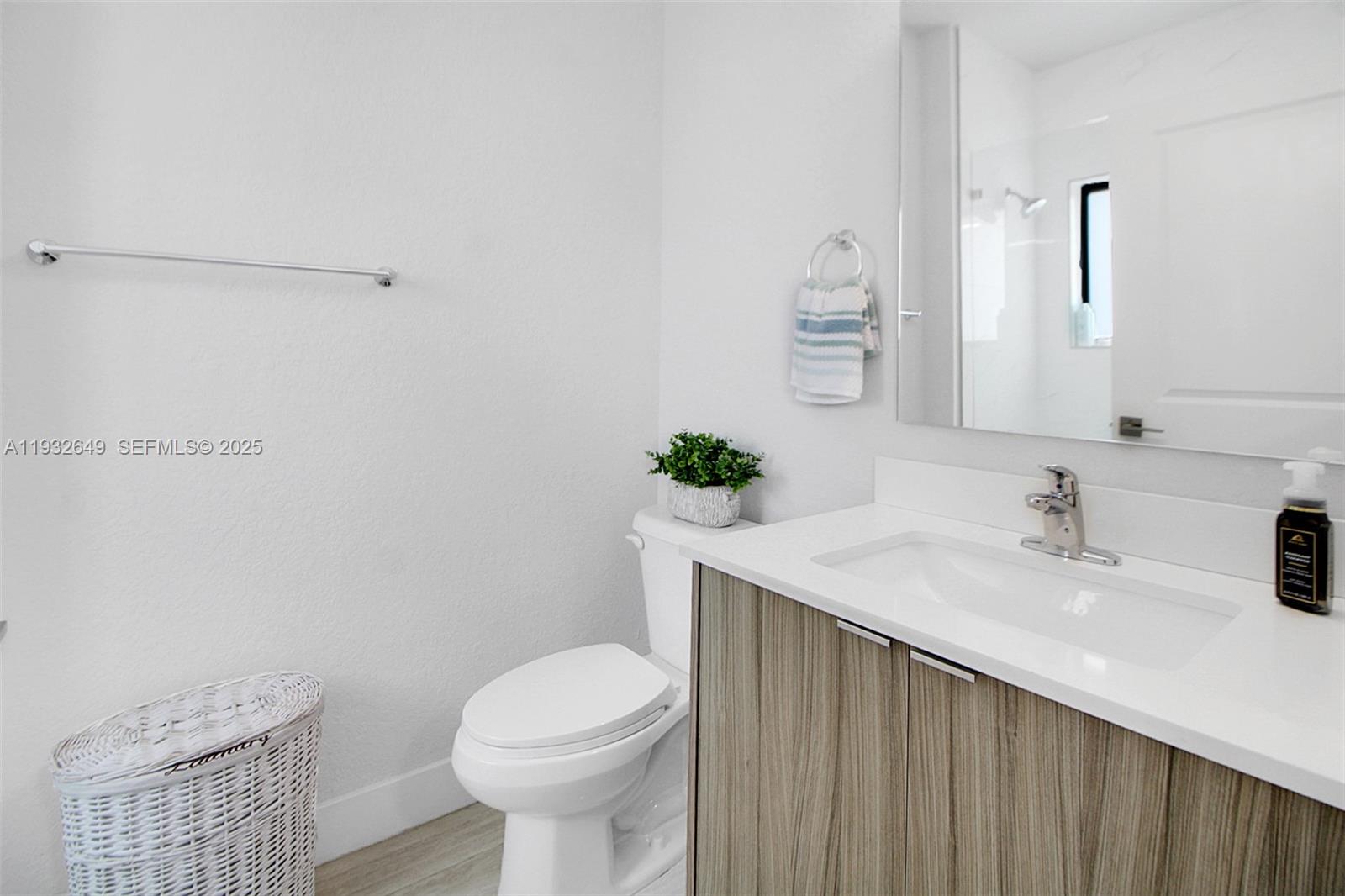 14671 Southwest 20th Street Miami, FL 33175 - Photo 47 of 53 a bathroom with a sink a toilet and mirror