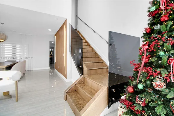 a view of entryway and hall with wooden floor