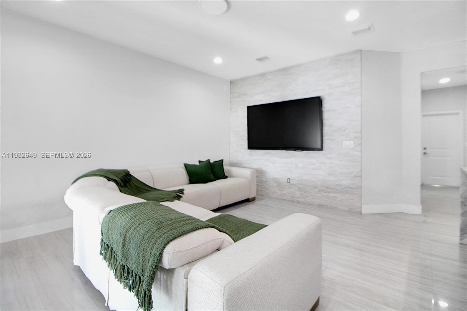 14671 Southwest 20th Street Miami, FL 33175 - Photo 6 of 50 a living room with furniture and a flat screen tv