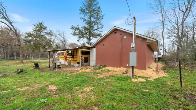 a view of a house with a yard and wooden fence