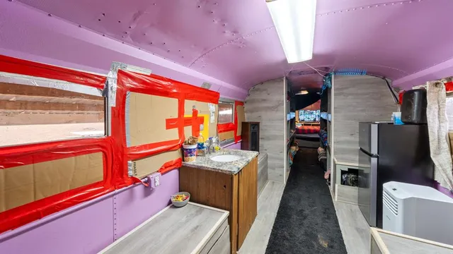 a living room with furniture a flat screen tv and a floor to ceiling window