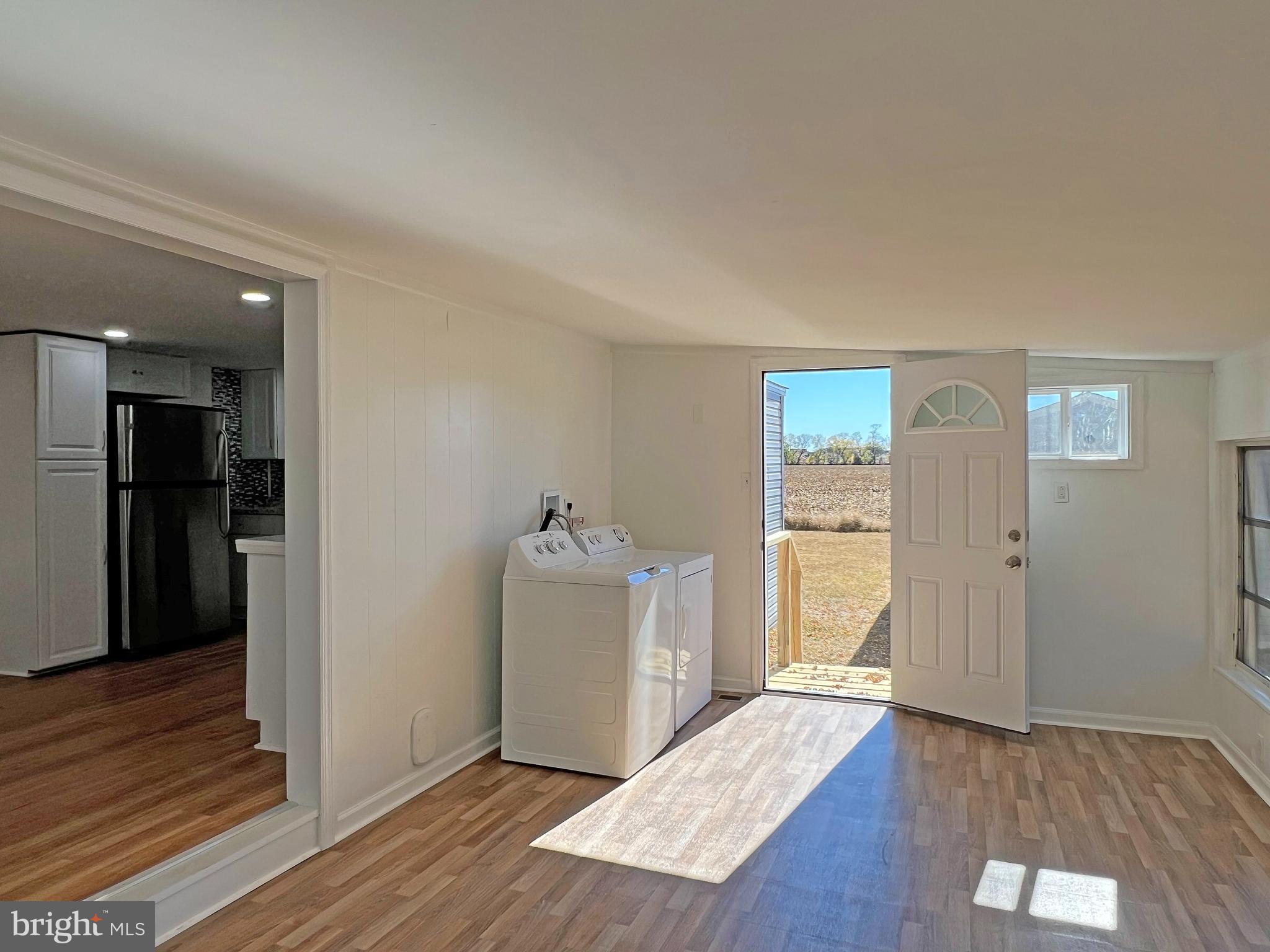 31658 Siham Road, Unit E42 Lewes, DE 19958 - Photo 12 of 35 an empty room with wooden floor and windows
