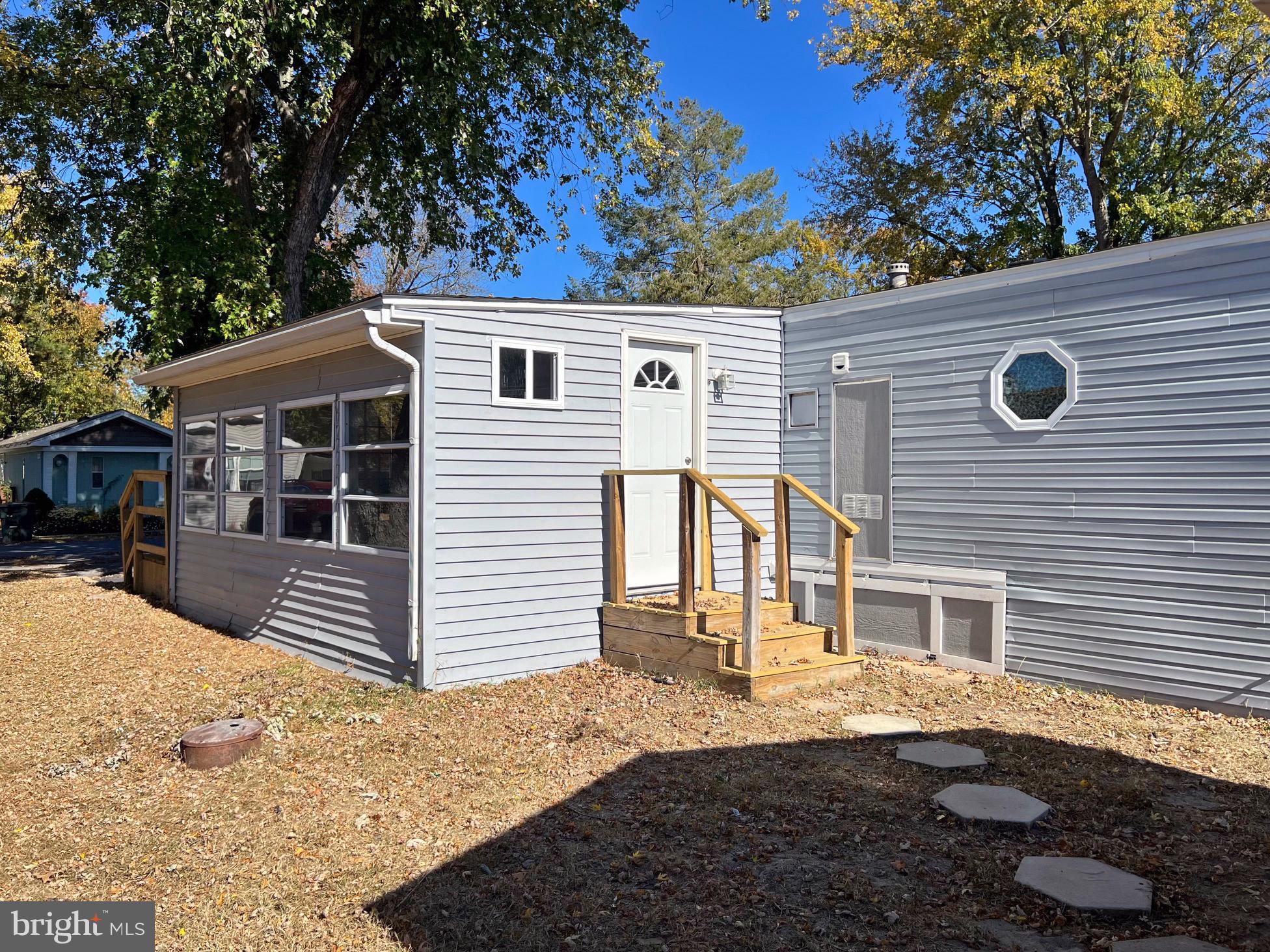 31658 Siham Road, Unit E42 Lewes, DE 19958 - Photo 14 of 35 a front view of a house with a yard
