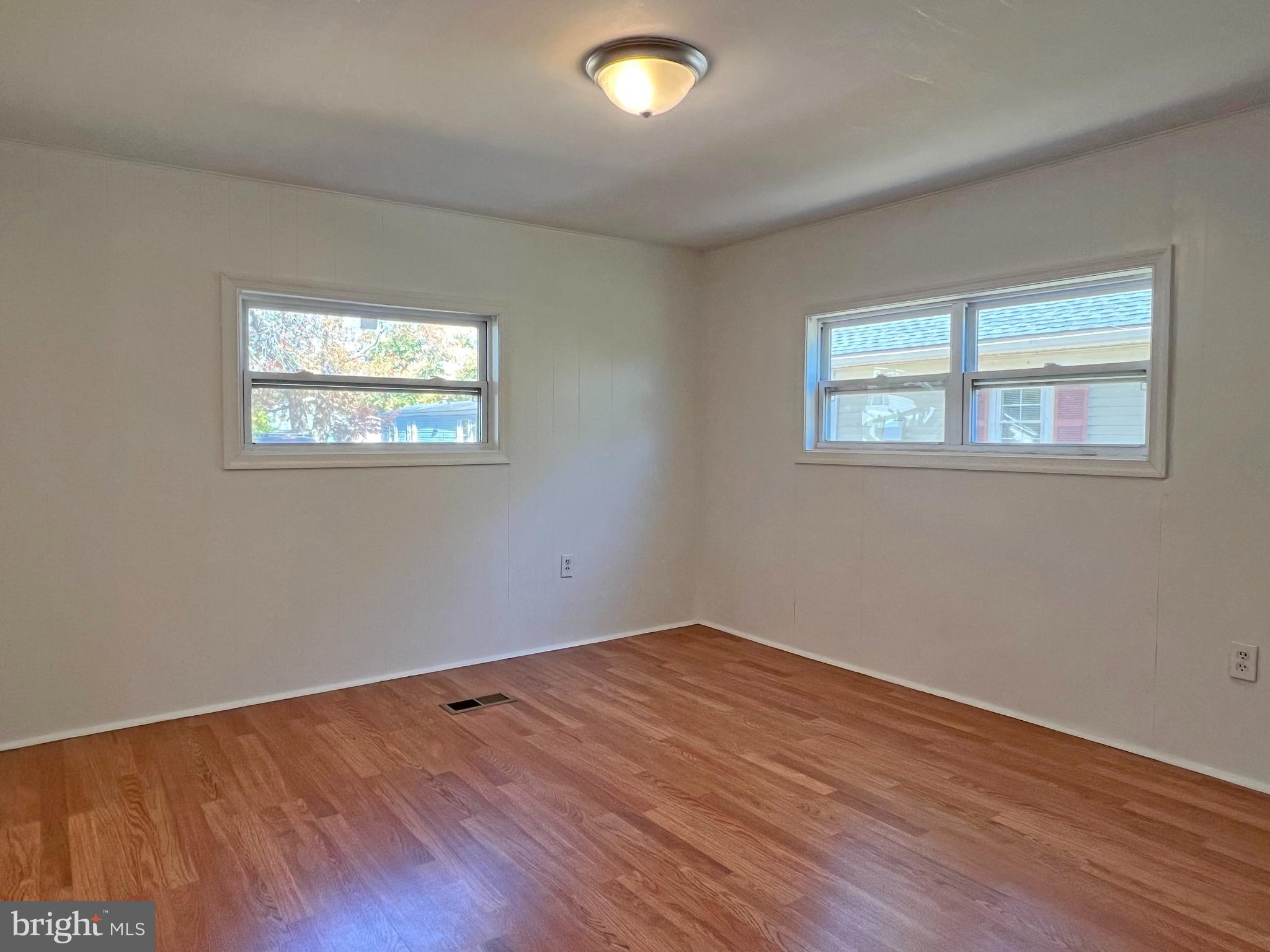 31658 Siham Road, Unit E42 Lewes, DE 19958 - Photo 15 of 35 a view of empty room with wooden floor and fan