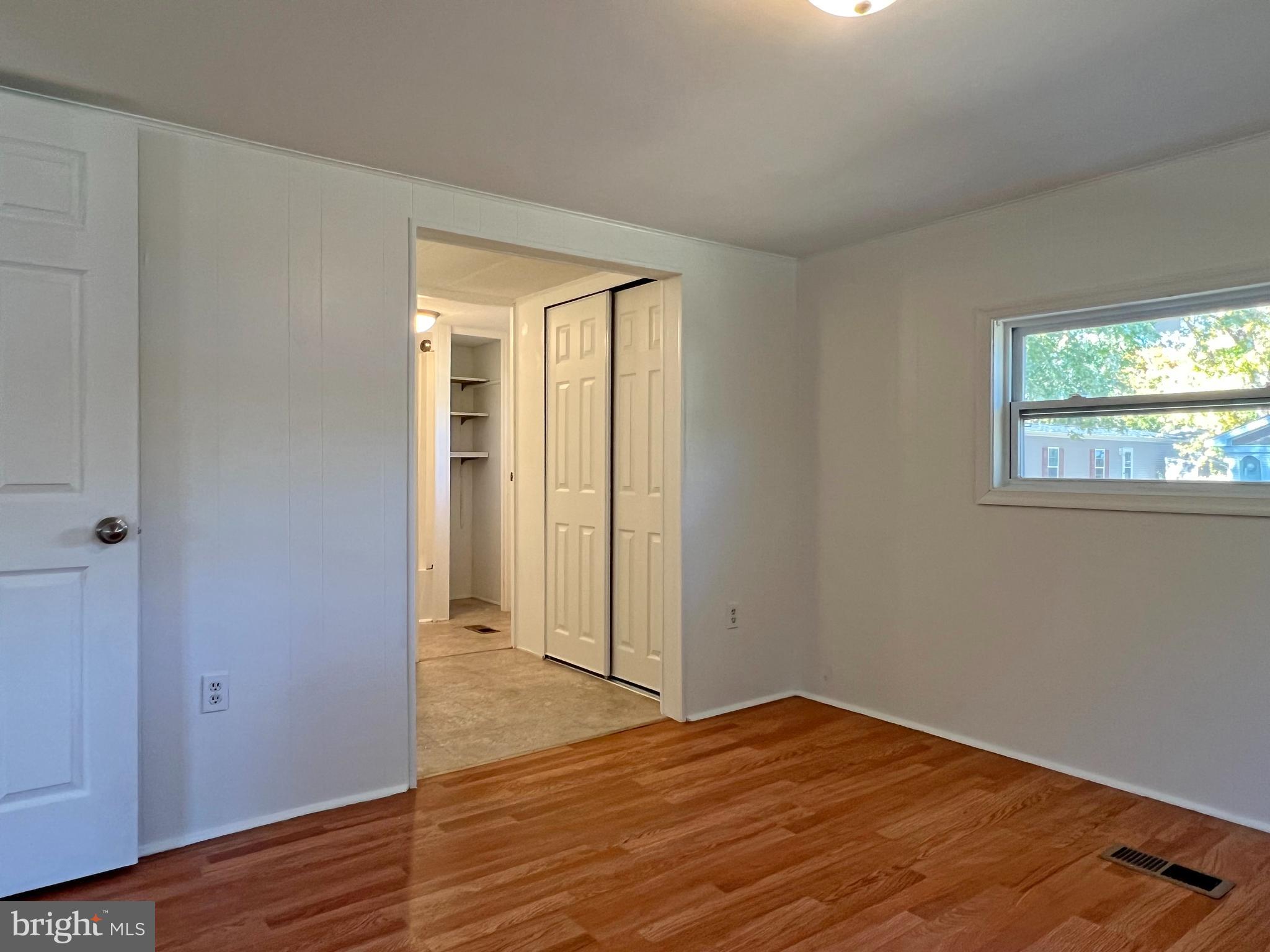 31658 Siham Road, Unit E42 Lewes, DE 19958 - Photo 16 of 35 a view of a room with wooden floor and windows