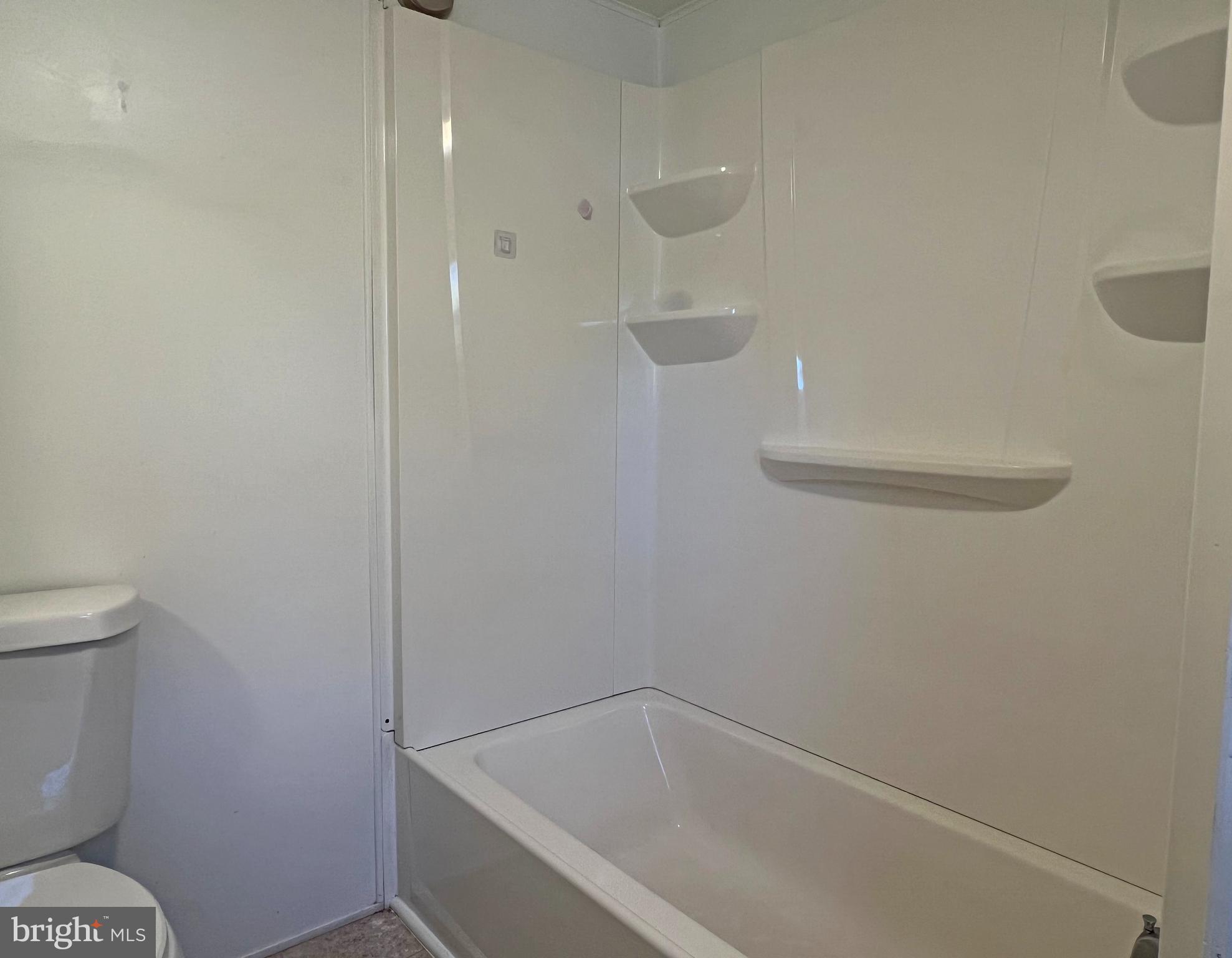 31658 Siham Road, Unit E42 Lewes, DE 19958 - Photo 18 of 35 a bathroom with a bathtub and toilet