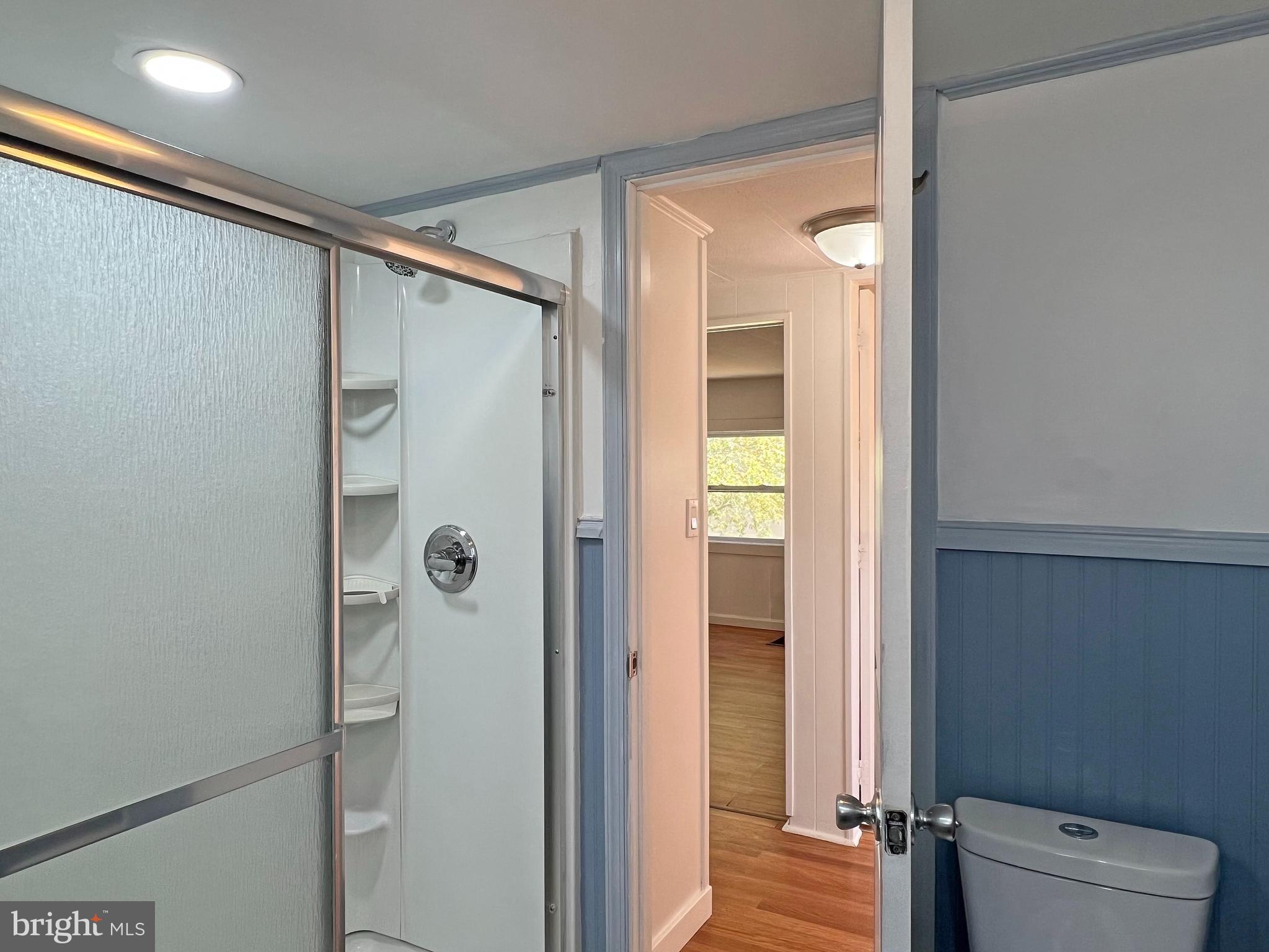 31658 Siham Road, Unit E42 Lewes, DE 19958 - Photo 24 of 35 a bathroom with a shower and a glass door
