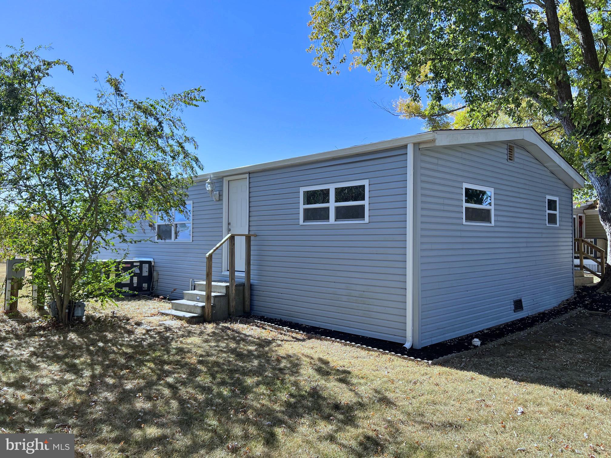 31658 Siham Road, Unit E42 Lewes, DE 19958 - Photo 29 of 35 a front view of a house with a yard