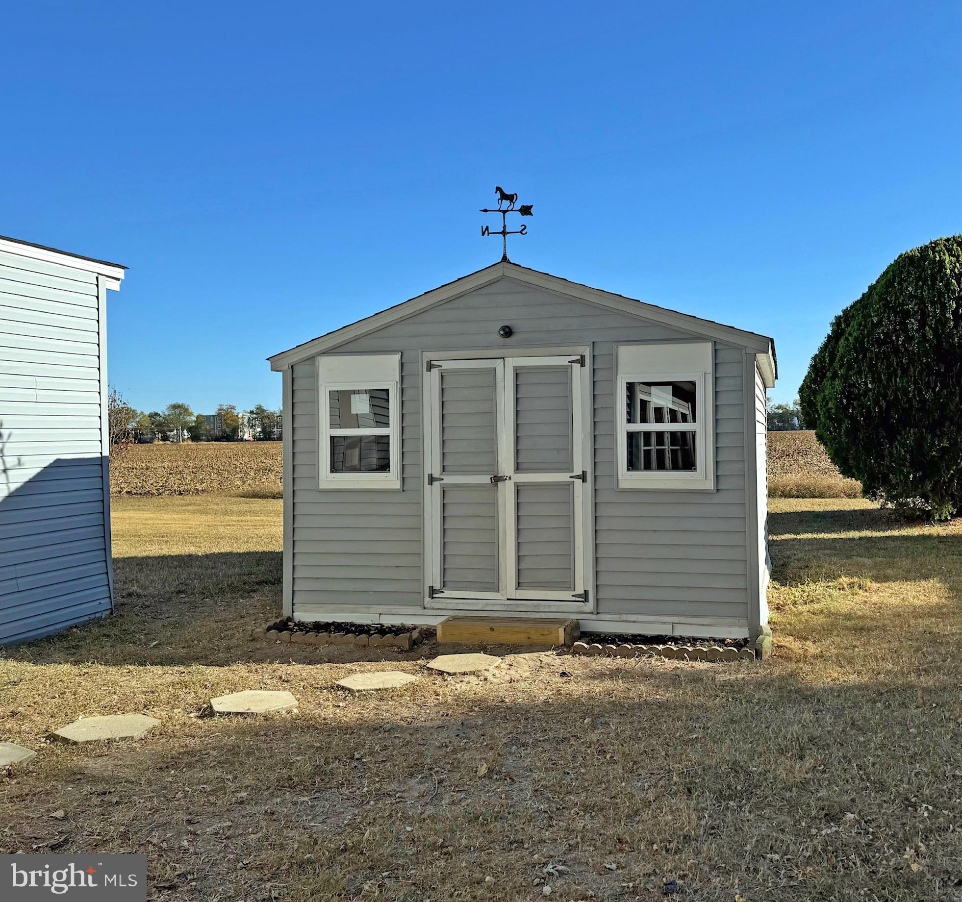 31658 Siham Road, Unit E42 Lewes, DE 19958 - Photo 31 of 35 a front view of a house with a yard