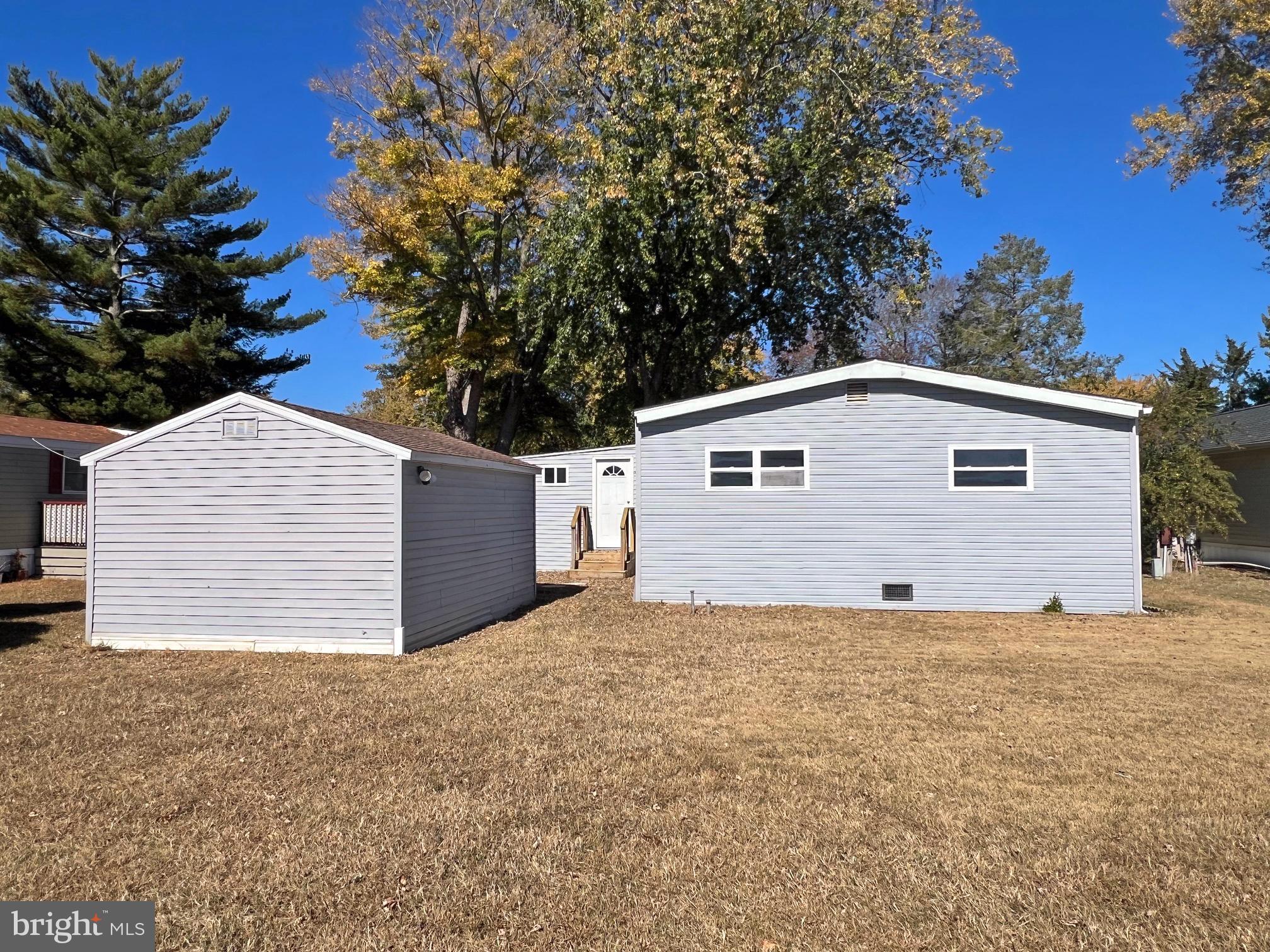 31658 Siham Road, Unit E42 Lewes, DE 19958 - Photo 33 of 35 a view of a house with a yard and garage