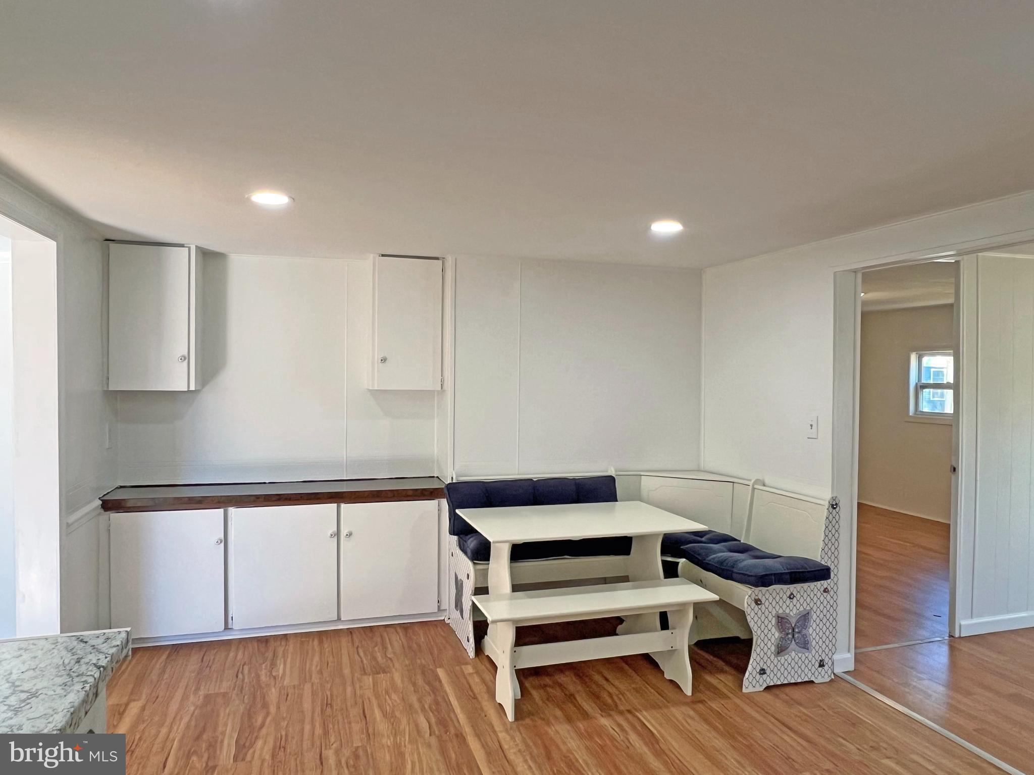 31658 Siham Road, Unit E42 Lewes, DE 19958 - Photo 5 of 35 a view of a kitchen with wooden floor and electronic appliances