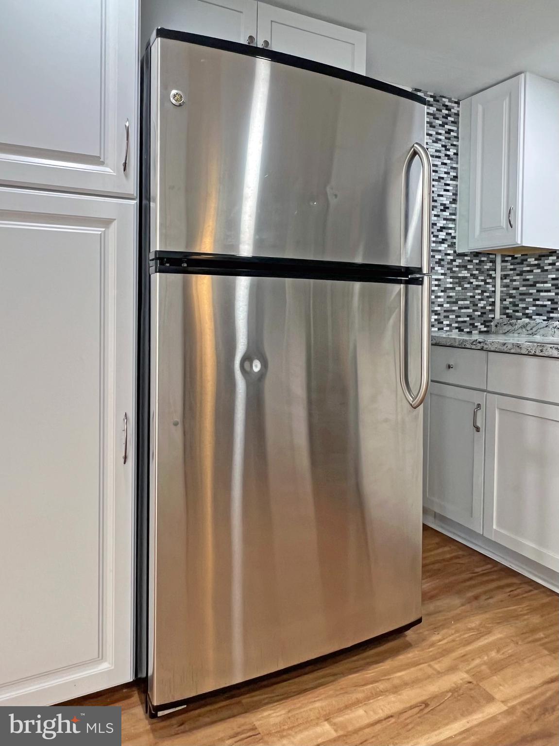 31658 Siham Road, Unit E42 Lewes, DE 19958 - Photo 7 of 35 a view of a refrigerator in kitchen with a refrigerator