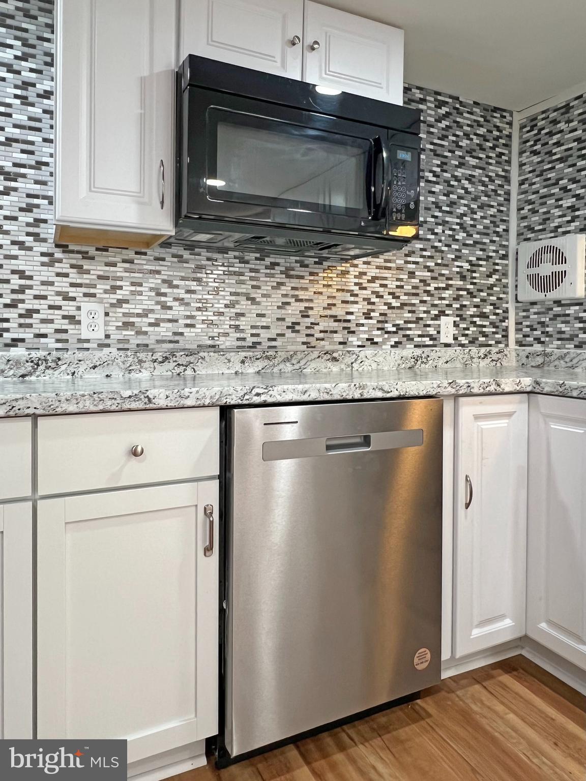 31658 Siham Road, Unit E42 Lewes, DE 19958 - Photo 9 of 35 a kitchen with appliances cabinets and a counter top space