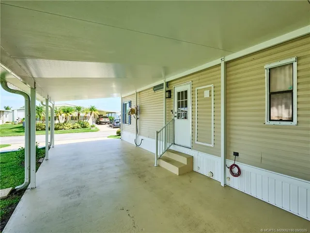 a room with gym equipment and large windows