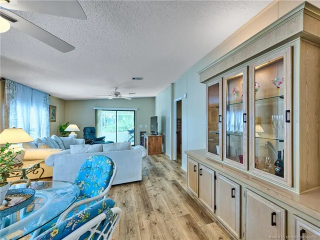 a living room with furniture chandelier and a large window